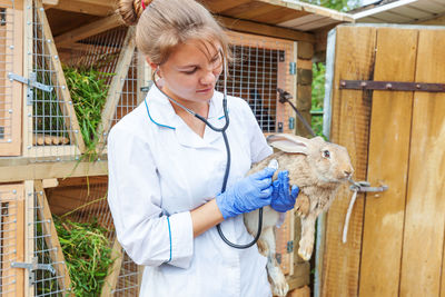 Portrait of female doctor holding clipboard