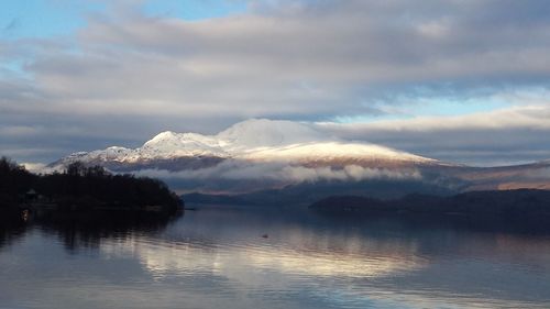 Scenic view of lake against sky during winter