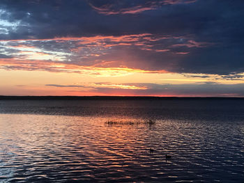 Scenic view of sea against romantic sky at sunset