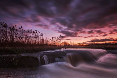 River stream against sky during sunset