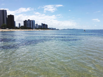 Scenic view of sea and buildings against sky