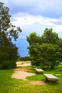 Scenic view of grassy field against cloudy sky