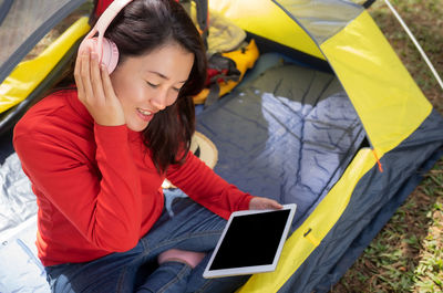 High angle view of young woman using mobile phone