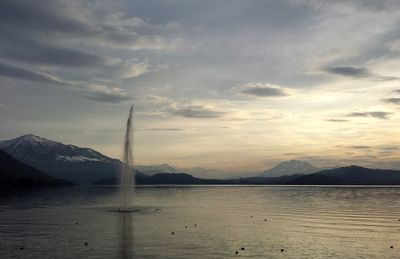 Scenic view of lake against cloudy sky