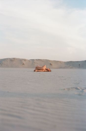 MAN ON SHORE AGAINST SKY