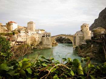 Mostar bridge with the view of mountain and lake