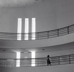 Full length of woman standing on railing