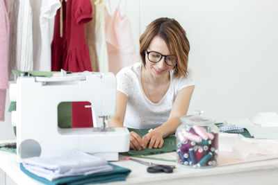 Smiling fashion designer working at boutique