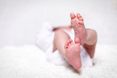 Close-up of baby feet lying on bed