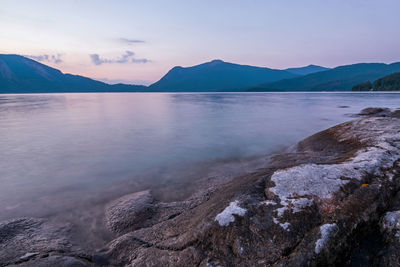 Scenic view of sea and mountains against sky