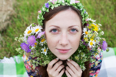 Portrait of smiling woman wearing flowers 