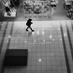 Blurred motion of people walking on tiled floor