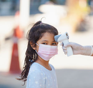 Girl getting temperature checked