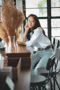 Portrait of smiling girl sitting at cafe