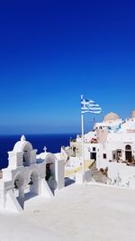 High angle view of building by sea against blue sky