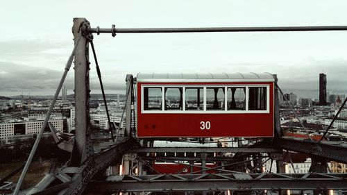 Train on railroad track in city against sky