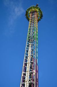 Low angle view of drop tower against blue sky