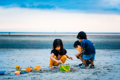 Children playing with toy on beach