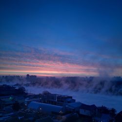 High angle view of buildings against sky during sunset