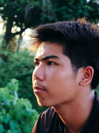 Close-up portrait of young man looking away