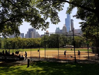 People in park with city in background