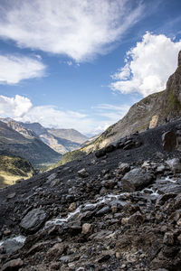 Scenic view of mountains against cloudy sky