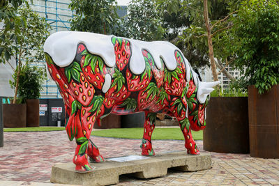 Red sculpture on footpath in park