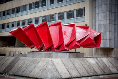 Red umbrella against built structure