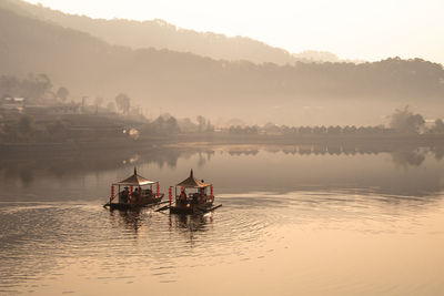 Ban ruk thai mae hong son  thailand. view of chinese yunnan lakeside village and chinese style boat