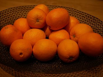 High angle view of oranges in basket on table