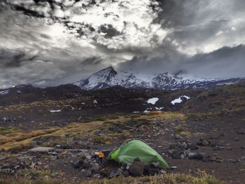 Scenic view of mountains against cloudy sky