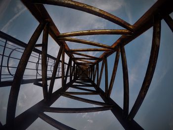 Low angle view of metal against sky