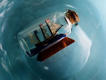 High angle view of ship in a bottle floating on blue water