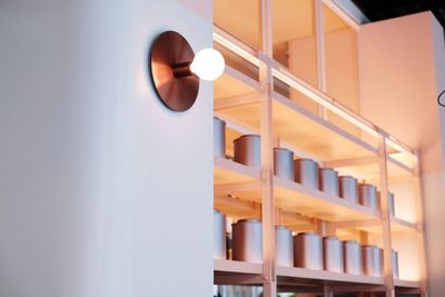 Low angle view of illuminated lights on wall in building