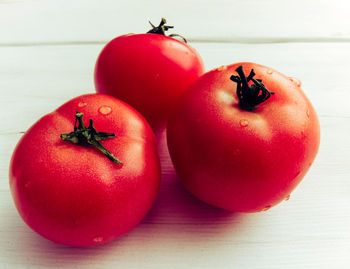 Close-up of wet tomatoes on table