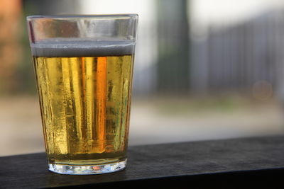 Close-up of beer glass on table