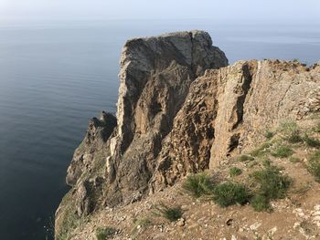 Rock formations in sea against sky