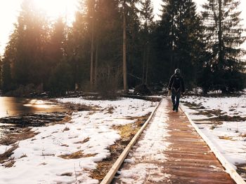 People walking on snow covered landscape