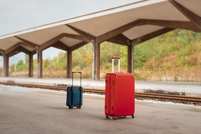 Red train on railroad station platform