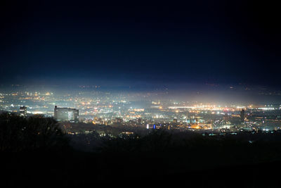 High angle view of illuminated buildings in city at night