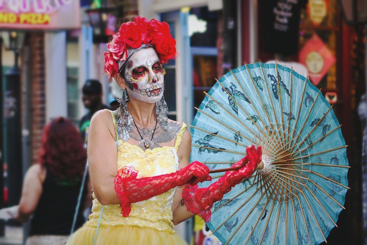 focus on foreground, incidental people, art and craft, human representation, creativity, art, sculpture, close-up, celebration, cultures, tradition, animal representation, statue, street, retail, decoration, red, outdoors, religion