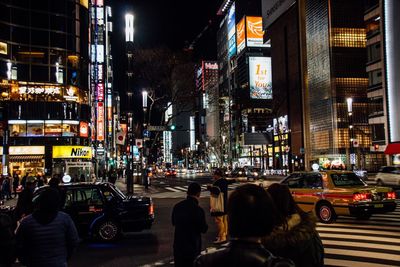 People on city street at night