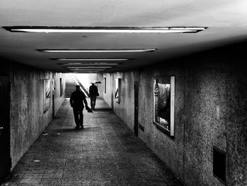 Rear view of woman walking in corridor