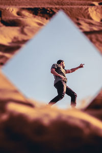 Low angle view of woman on rock