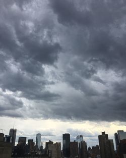 City skyline against cloudy sky