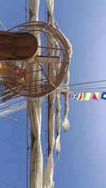 Low angle view of ferris wheel against blue sky