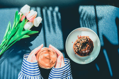 High angle view of person holding ice cream on table