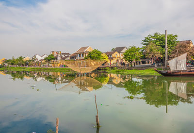 Scenic view of lake by building against sky