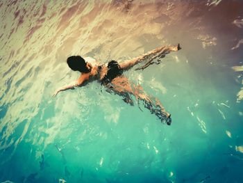 High angle view of woman swimming in sea