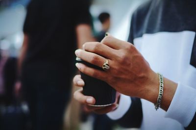 Midsection of man holding disposable cup